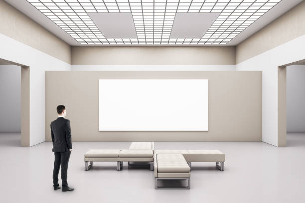 istock Businessman looking on blank poster 1263042771