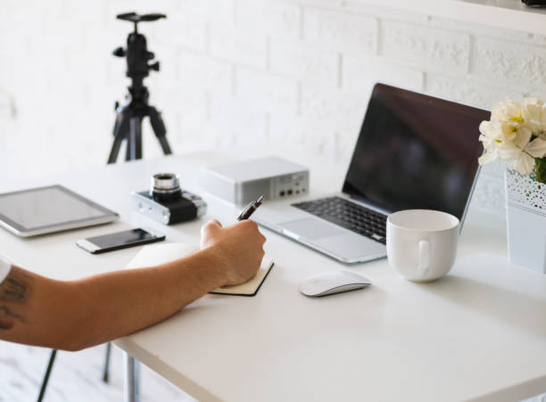 istock Photographer working on laptop computer, in photography studio. 1263044347