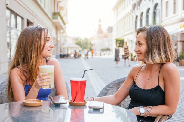 istock Two female friends talking, drinking lemonade and having fun in a restaurant 1263052013