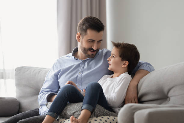 istock Little son having confidence conversation with father at home 1263052889