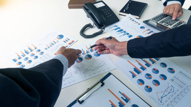 istock The hand that points to the graph is a business analysis and calculation. 1263056451