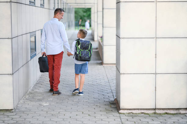 istock Father walking his son to school. 1263057856