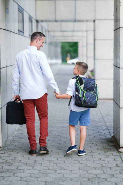 istock Father walking his son to school. 1263057888
