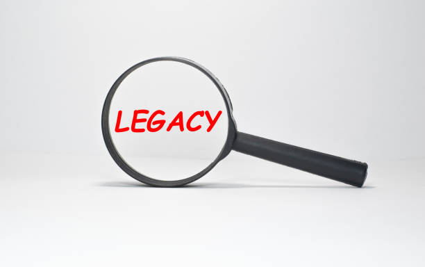 istock Legacy text, inscription, phrase is written in a notebook that lies on a dark table and a pen. Business concept. 1263057898