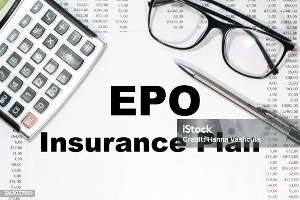 On A Light Background Between The Calculator And Pen Epo Stock Photo - Download Image Now