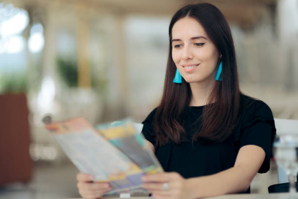 istock Smiling Woman Reading a Magazine 1263061678