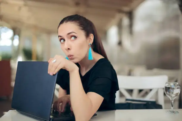 Photo of Woman with Laptop Worried About Online Privacy of Personal Data
