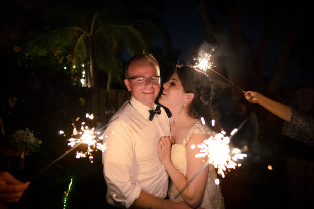 istock Newlywed couple surrounded by sparkle stick lights 1263063248