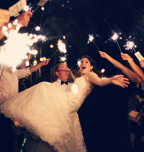 Newlyweds walking among sparkle lights