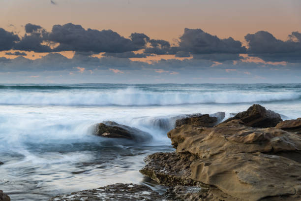 istock Sunrise Seascape with a low cloud bank and waves 1263064162