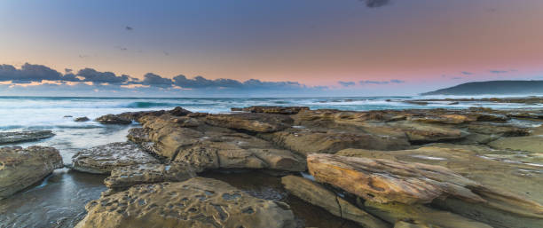 istock Sunrise seascape panorama with rock platform 1263064189