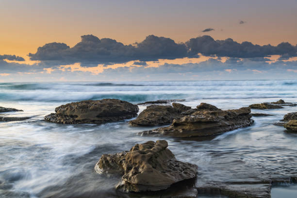 istock Sunrise Seascape with a low cloud bank and waves 1263064280