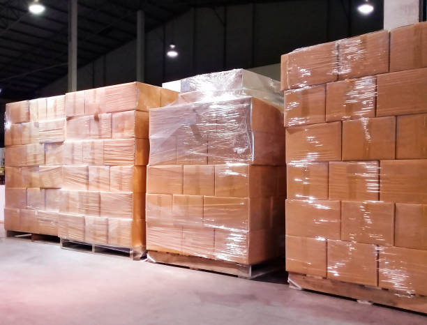 istock Stack of shipment boxes on wooden pallet at warehouse storage. package box, packaging. Manufacturing warehouse cargo shipping goods. Logistics and transportation. 1263075779