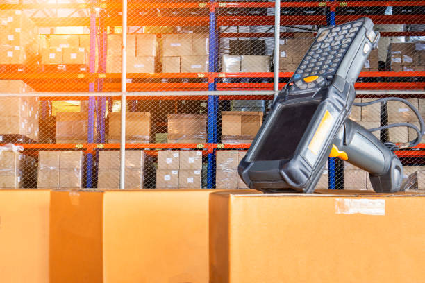 istock Barcode scanner on cardboard boxes in distribution warehouse. Warehouse inventory management. Computer equipment for inventory management. 1263076333