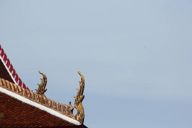 shiny on the rooftops of temple in thailand with cloud and blue sky backgroud