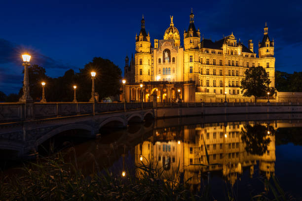 Famous Schwerin Castle in Eastern part of Germany seen at night. The Castle is situated on an island in the Lake Schwerin.