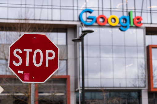 Seattle, USA - Feb 4, 2020: A stop sign across from the new Google building entrance in the south lake union late in the day.