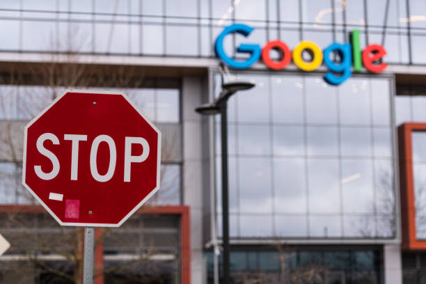 Stop Seattle, USA - Feb 4, 2020: A stop sign across from the new Google building entrance in the south lake union late in the day. big tech stock pictures, royalty-free photos & images