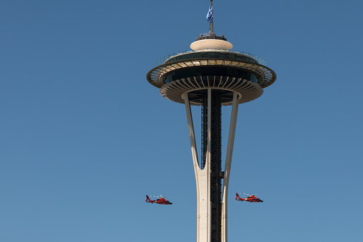 Seattle, USA – May 8, 2020: Late in the day coast guard choppers flying over Seattle to support frontline workers during the covid-19 pandemic and stay at home order.