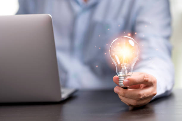 istock Businessman hand holding lightbulb with orange glowing for creative thinking idea concept. 1263082631
