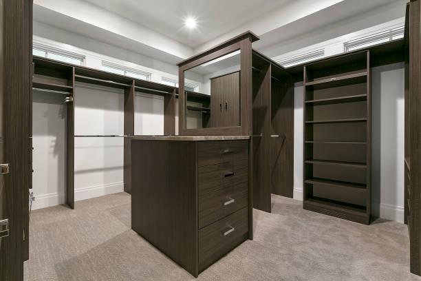 istock Nice walk in closet with dark wood shelves 1263083374