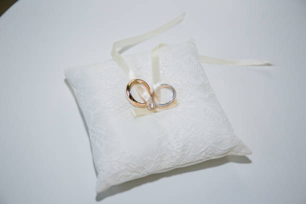 istock gold wedding rings on a pillow for rings 1263087075