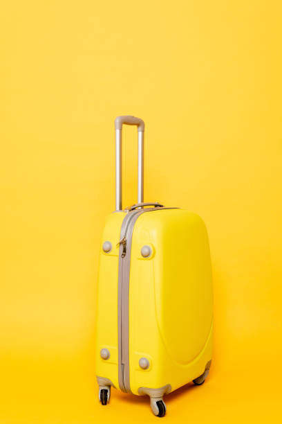 istock colorful travel bag on yellow background 1263087152