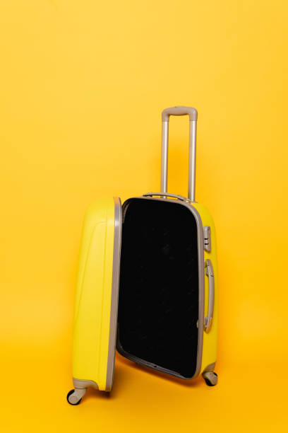 istock open empty travel bag on yellow background 1263087169