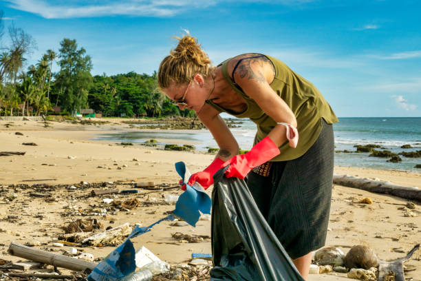 istock One woman cleaning ocean pollution Ko Lanta beach 1263087930