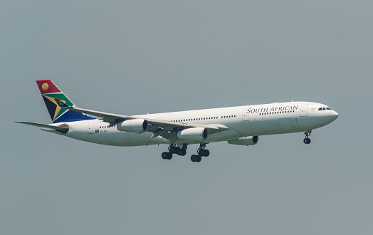 Hong Kong, China – August 30, 2014: South African Airways A340 is flying in the sky above Hong Kong International Airport, is the state-owned flag carrier airline of South Africa.