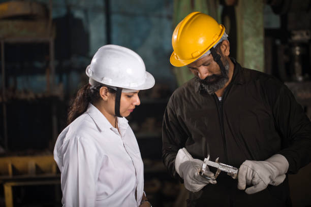 istock Maintenance engineer with mechanic measuring using micrometer at factory 1263091062