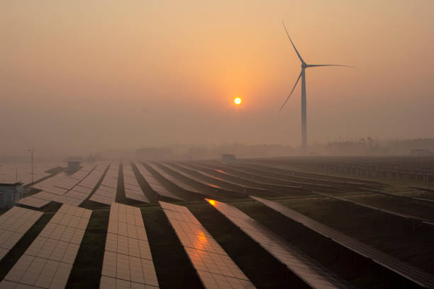 istock Wind power and solar power plants at sunrise and sunset 1263095018