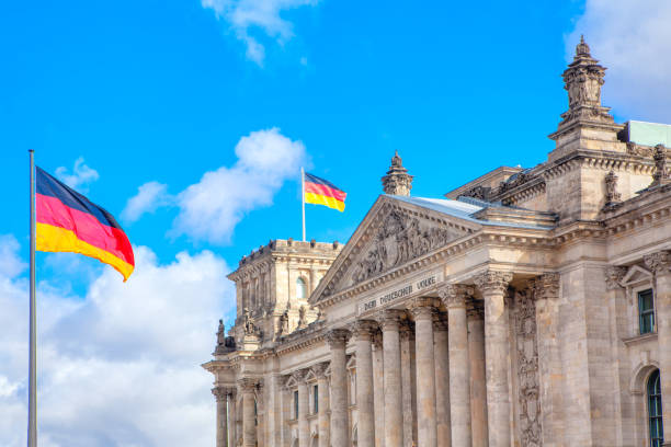 istock Reichstag building and german flags 1263095753