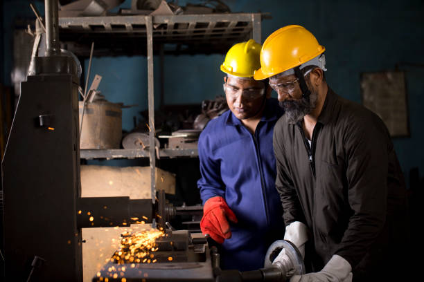istock Two lathe operators grinding and finishing metal product 1263100709