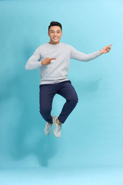 istock side view of a young man in suit blue background 1263101364