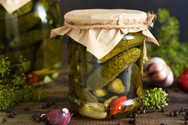 istock Pickled cucumbers with dill and garlic in a glass jar. 1263101479