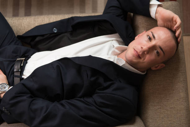 istock Young Businessman Sleeping on Sofa at Home 1263101700