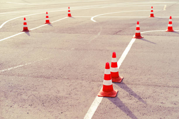 Playground with cones in the school of driving passing the exam for obtaining a car license Playground with cones in the school of driving passing the exam for obtaining a car license traffic cone photos stock pictures, royalty-free photos & images