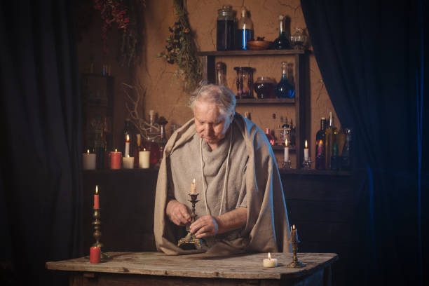 istock elderly alchemist monk  with candle 1263101959