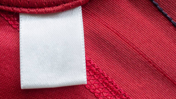 istock White blank laundry care clothes label on red polyester sport shirt background 1263102085