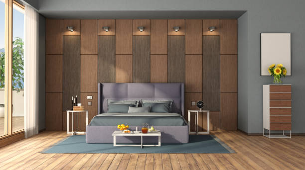 istock Modern bedroom with double bed against wooden panel 1263102946