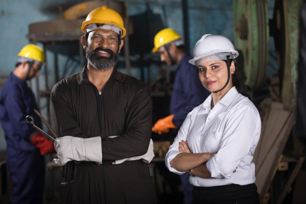 istock Female engineer and mechanic with protective workwear at factory 1263103015