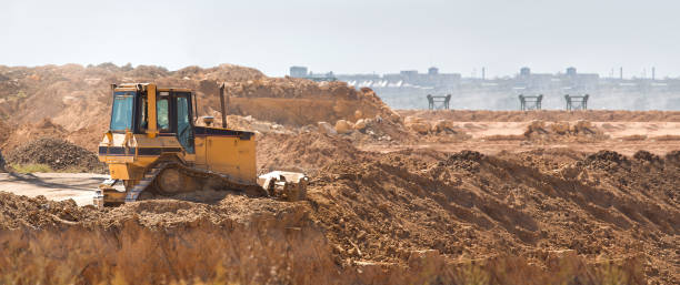istock bulldozer heavy machinery transport raking clay for landscape planning before construction, yellow crawler tractor doing work moving earth, nobody. 1263103090