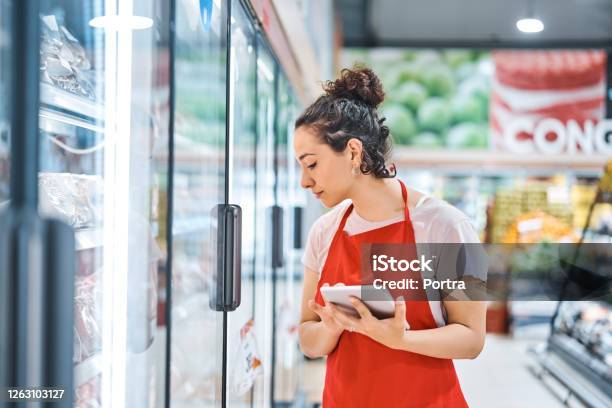 Saleswoman In Apron Working At Supermarket Stock Photo - Download Image Now - Supermarket, Occupation, Retail Clerk