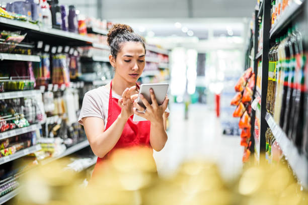 istock Saleswoman using digital tablet at supermarket 1263103130
