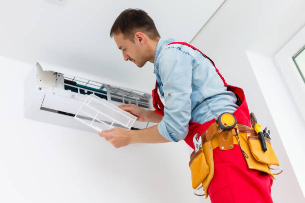 istock Young Man Repairing Air Conditioner Standing On Stepladder 1263103382