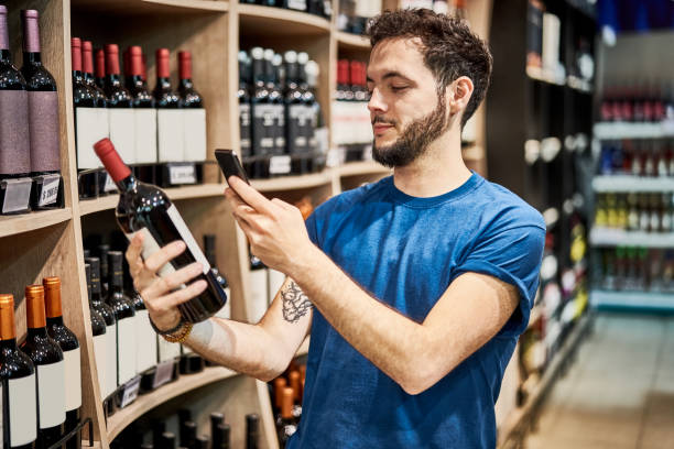 istock Male customer buying wine at store 1263103394