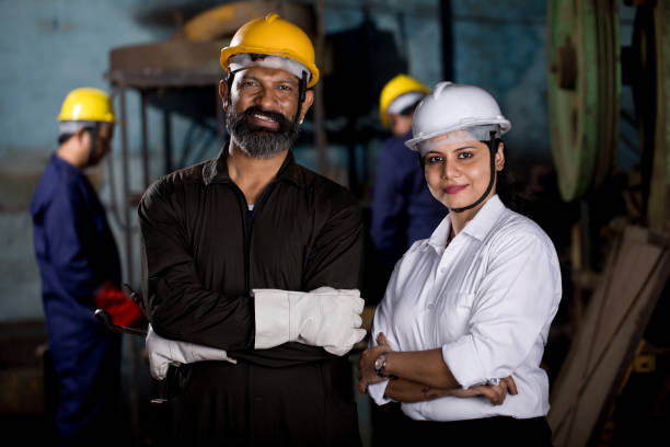 istock Female engineer and mechanic with protective workwear at factory 1263103427