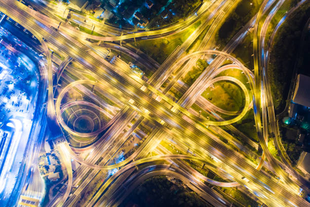 istock Intersection transport road with vehicle light movement 1263103789