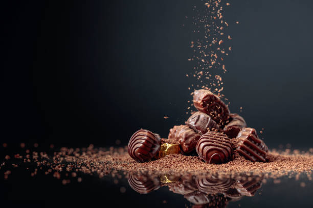 istock Chocolate candies on a black background sprinkled with chocolate chips. 1263104738